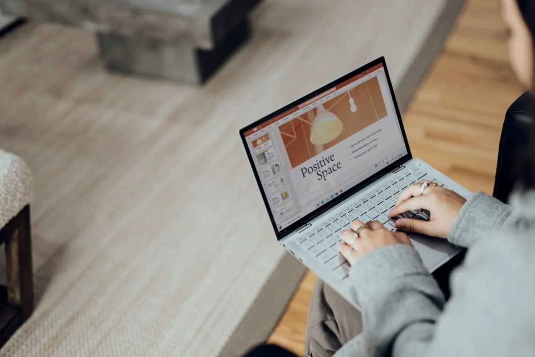 Three women in hijabs collaborating on digital advertising strategies around a table with laptops.